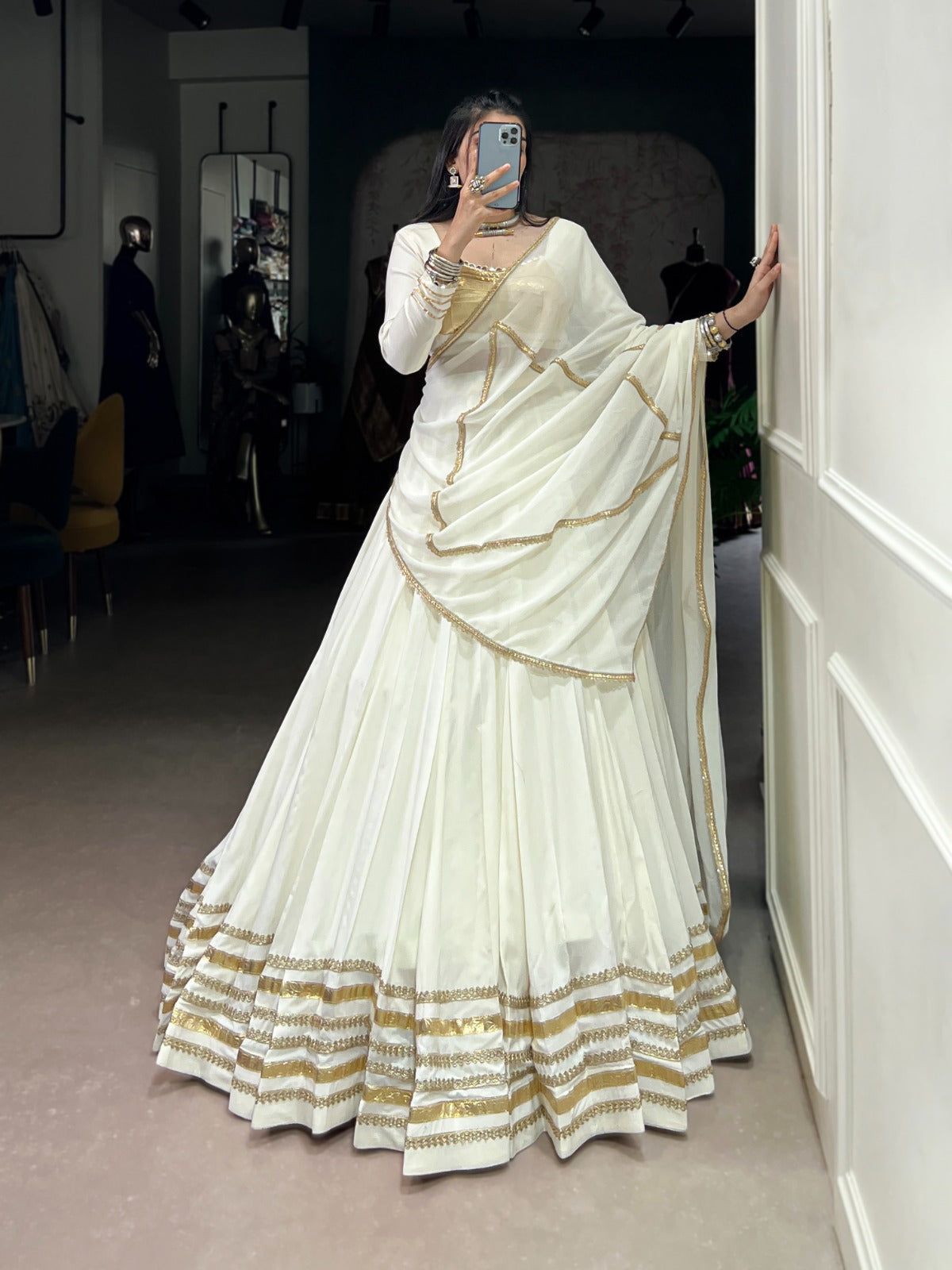 Regal White Lehenga Choli with Golden Zari Embellishments and Draped Dupatta